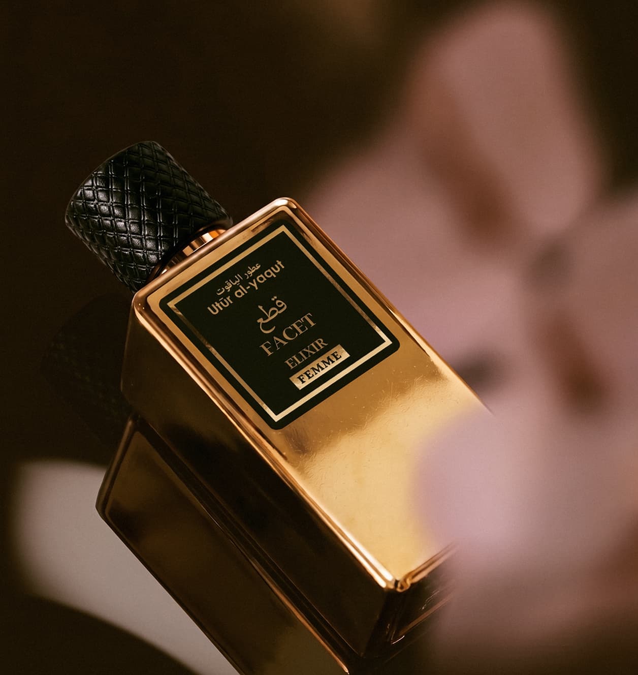 Utur Facet Elixir bottle held in hand